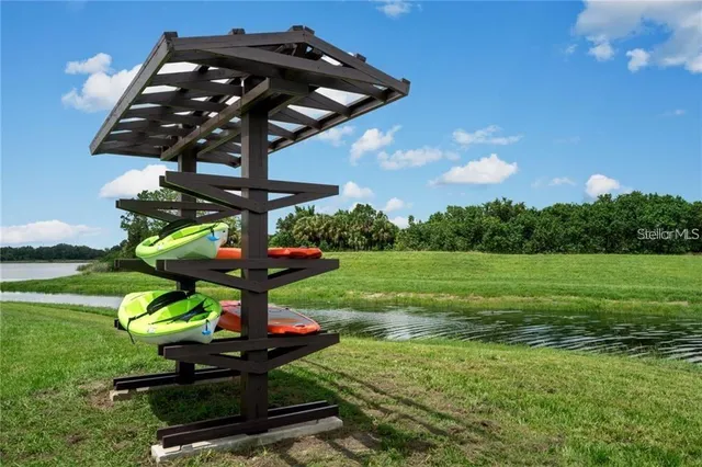 a view of a house with swimming pool and sitting area