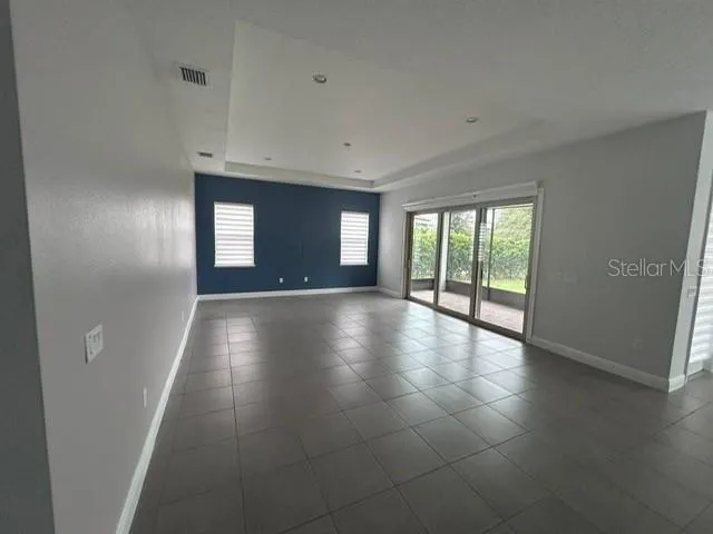 a bathroom with a granite countertop bathtub shower sink vanity mirror and toilet