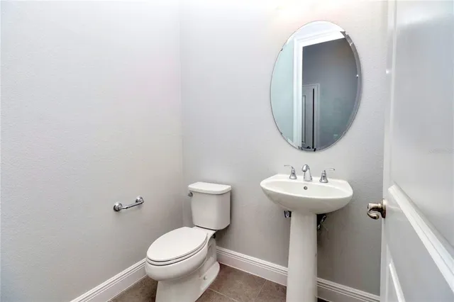 an empty room with kitchen view and a sink