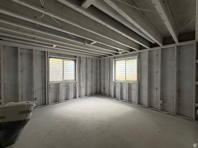 838 East Mountain Road Logan, UT 84321 - Photo 32 of 37 Unfinished basement space featuring exposed ceiling joists, framed walls, and two egress windows