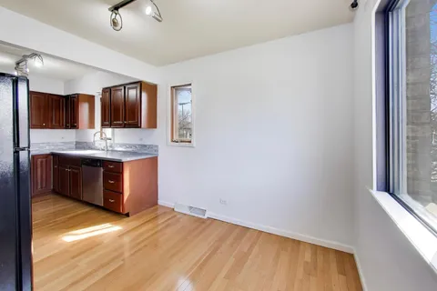 a kitchen with stainless steel appliances granite countertop a sink and a wooden cabinets