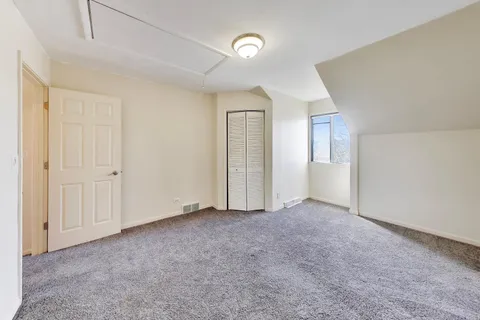 an empty room with windows and closet
