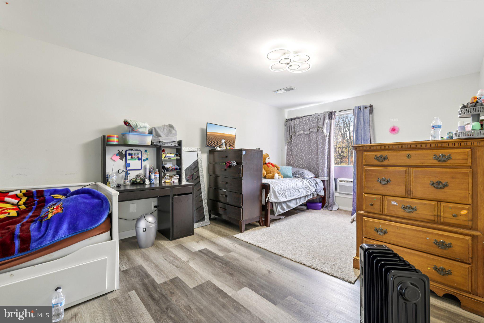 7969 Riggs Road, Unit 9 Hyattsville, MD 20783 - Photo 15 of 30 a bedroom with a bed and a tv