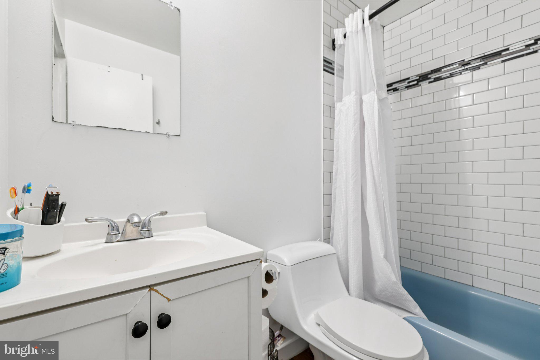 7969 Riggs Road, Unit 9 Hyattsville, MD 20783 - Photo 18 of 30 a bathroom with a sink a toilet and shower