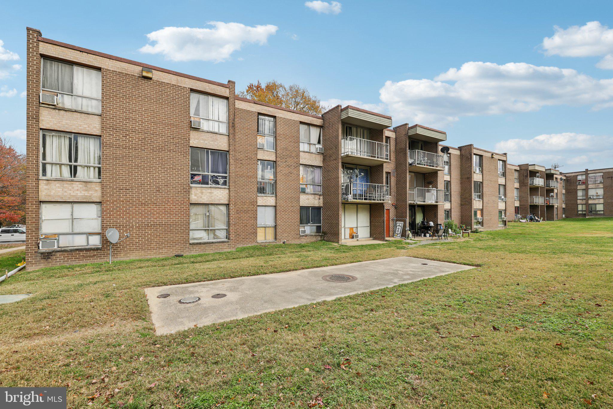7969 Riggs Road, Unit 9 Hyattsville, MD 20783 - Photo 22 of 30 a view of a big building next to a big yard