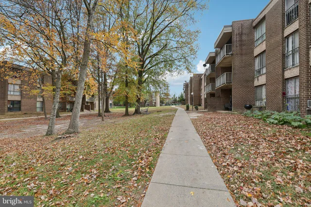 a view of a brick building next to a yard