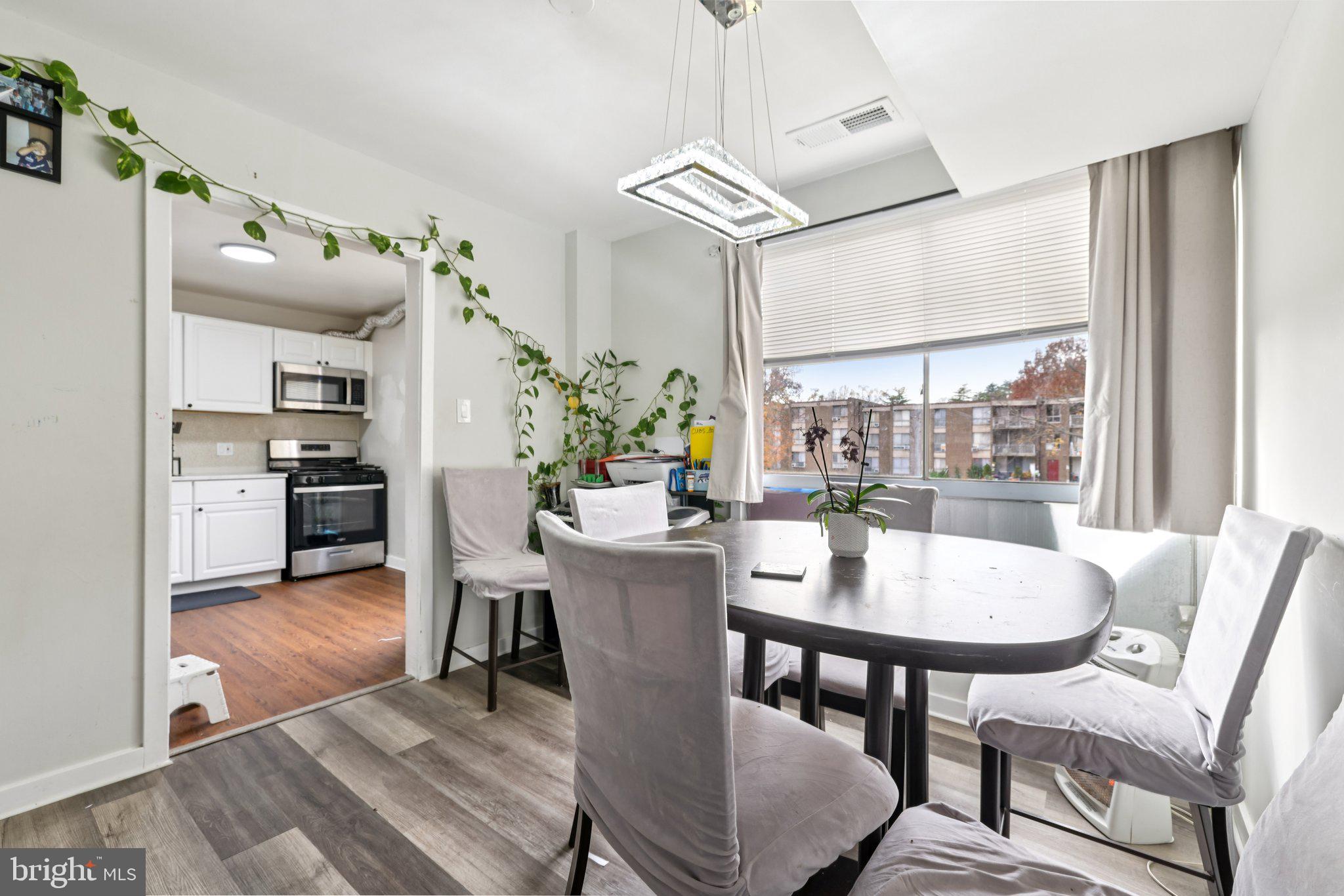 7969 Riggs Road, Unit 9 Hyattsville, MD 20783 - Photo 7 of 30 a view of a dining room with furniture window and wooden floor