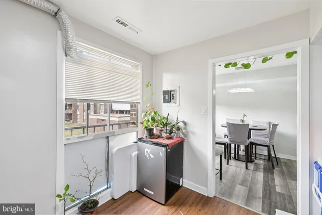 a view of a dining room with furniture window and wooden floor