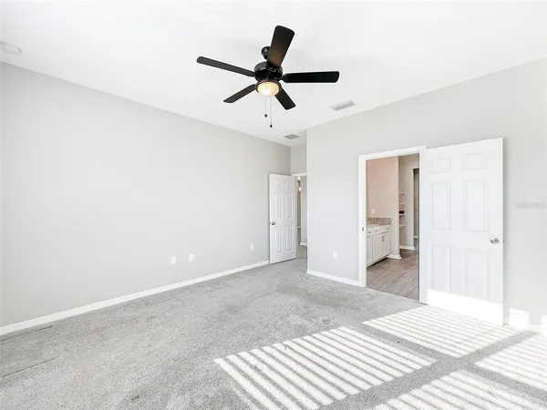 a view of a room with a ceiling fan