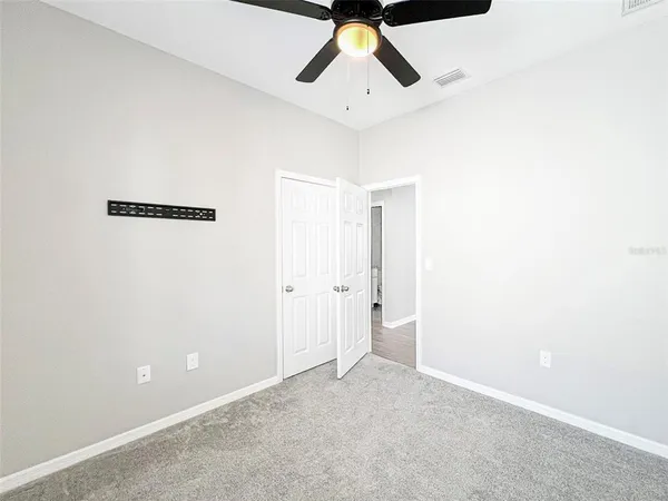 a view of a room with a ceiling fan