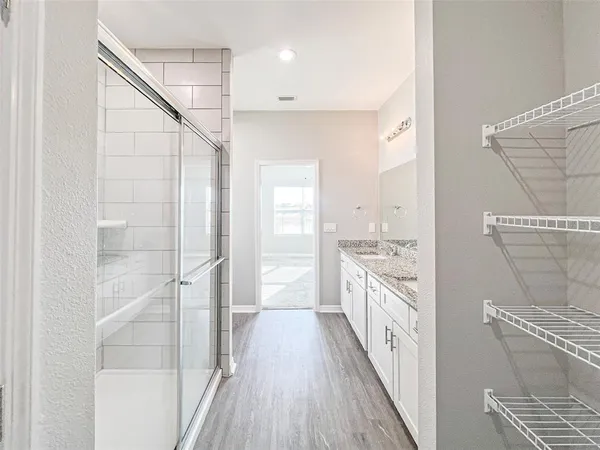 a view of a kitchen with a sink and wooden floor