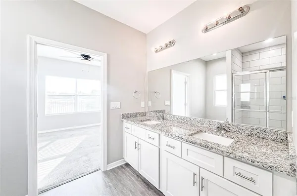 a bathroom with a granite countertop sink mirror and