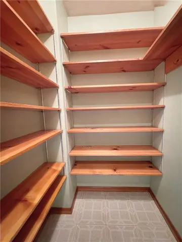 a view of room with stairs and a rug