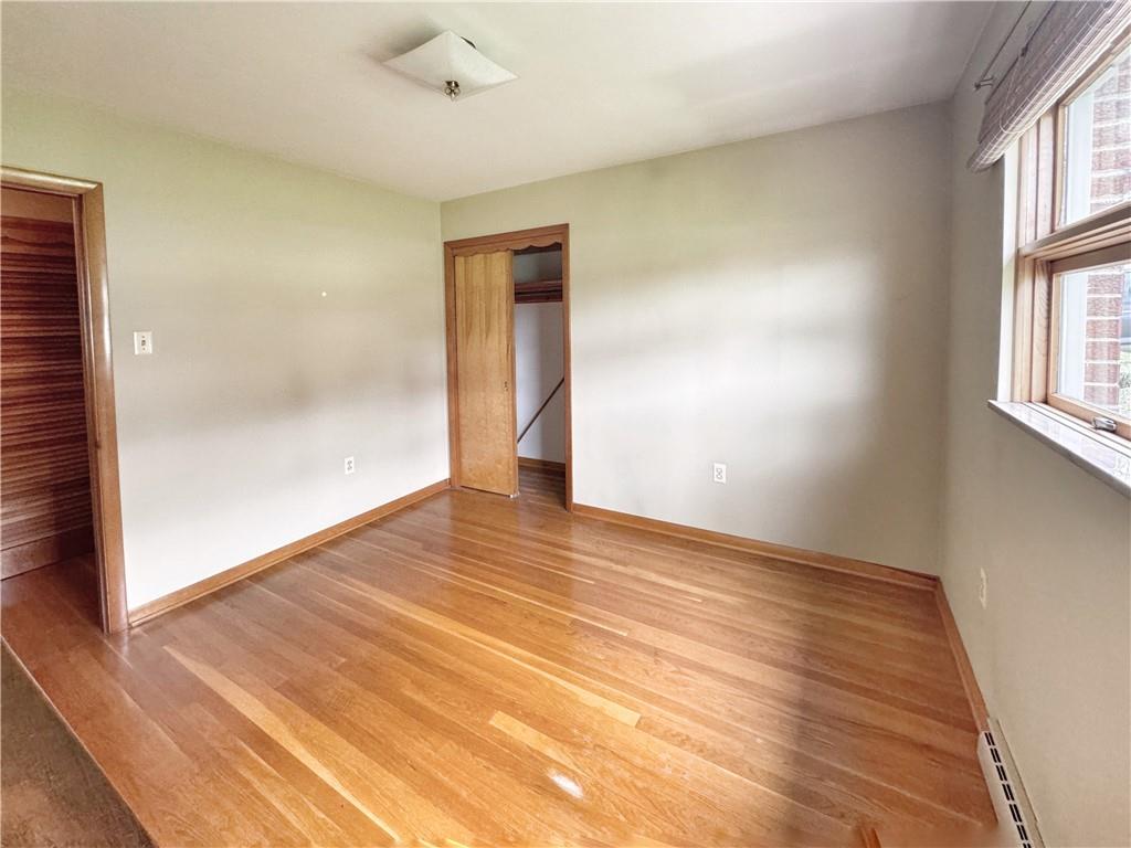 1215 Center Road Monaca, PA 15061 - Photo 21 of 33 an empty room with wooden floor and windows