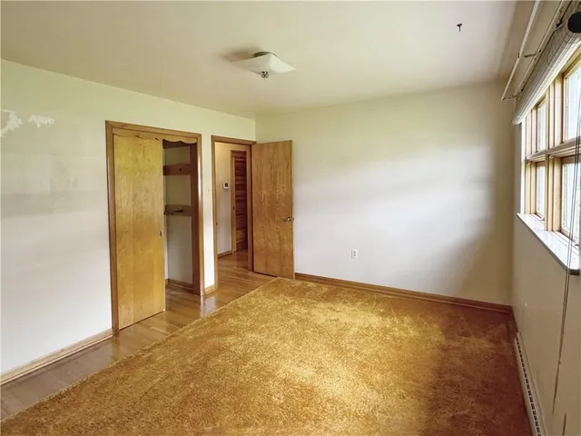 an empty room with windows and entrance
