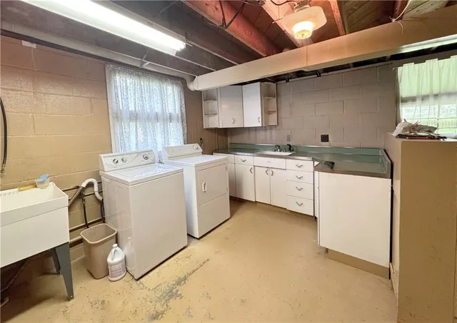 a utility room with sink dryer and washer