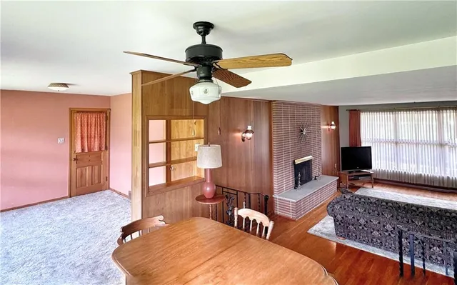 a living room with furniture ceiling fan and a window