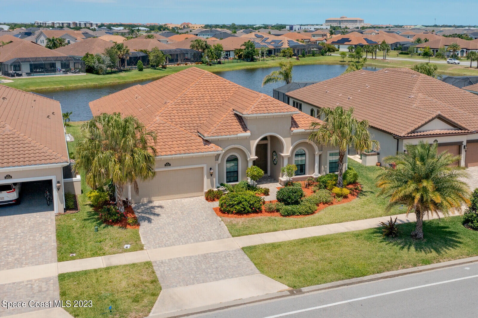 an aerial view of a house with garden space and lake view