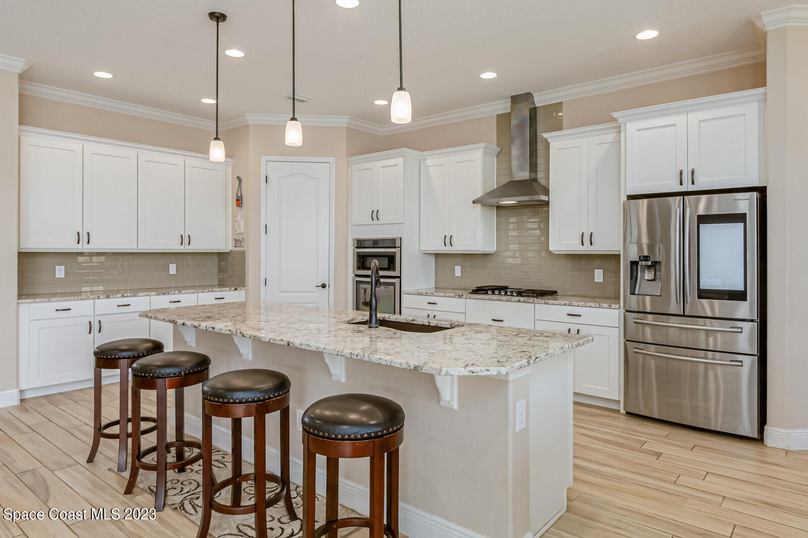 2928 Addison Drive Melbourne, FL 32940 - Photo 16 of 69 a kitchen with stainless steel appliances granite countertop a stove top oven a refrigerator a sink and chairs