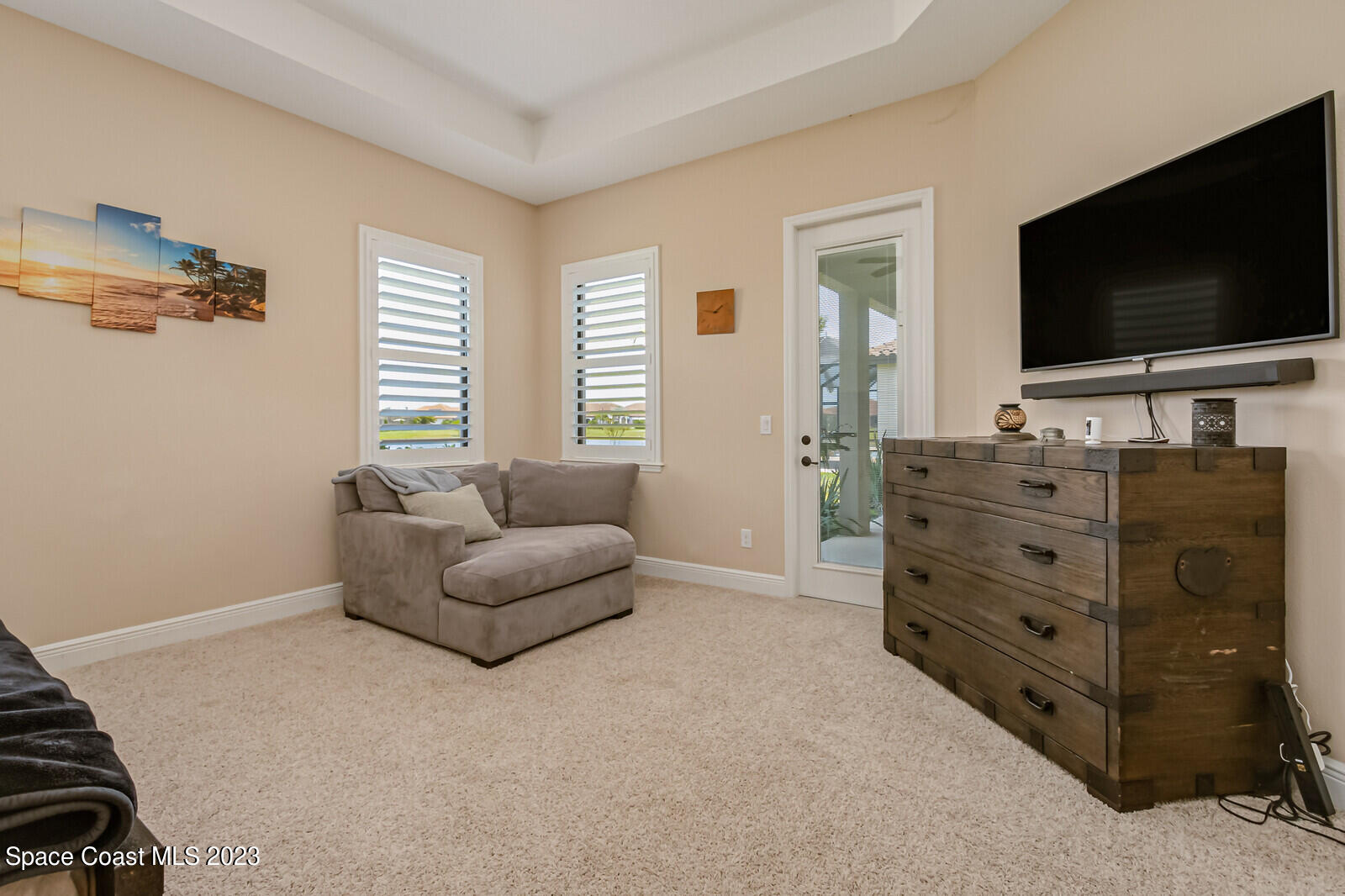 2928 Addison Drive Melbourne, FL 32940 - Photo 25 of 69 a living room with furniture and a flat screen tv