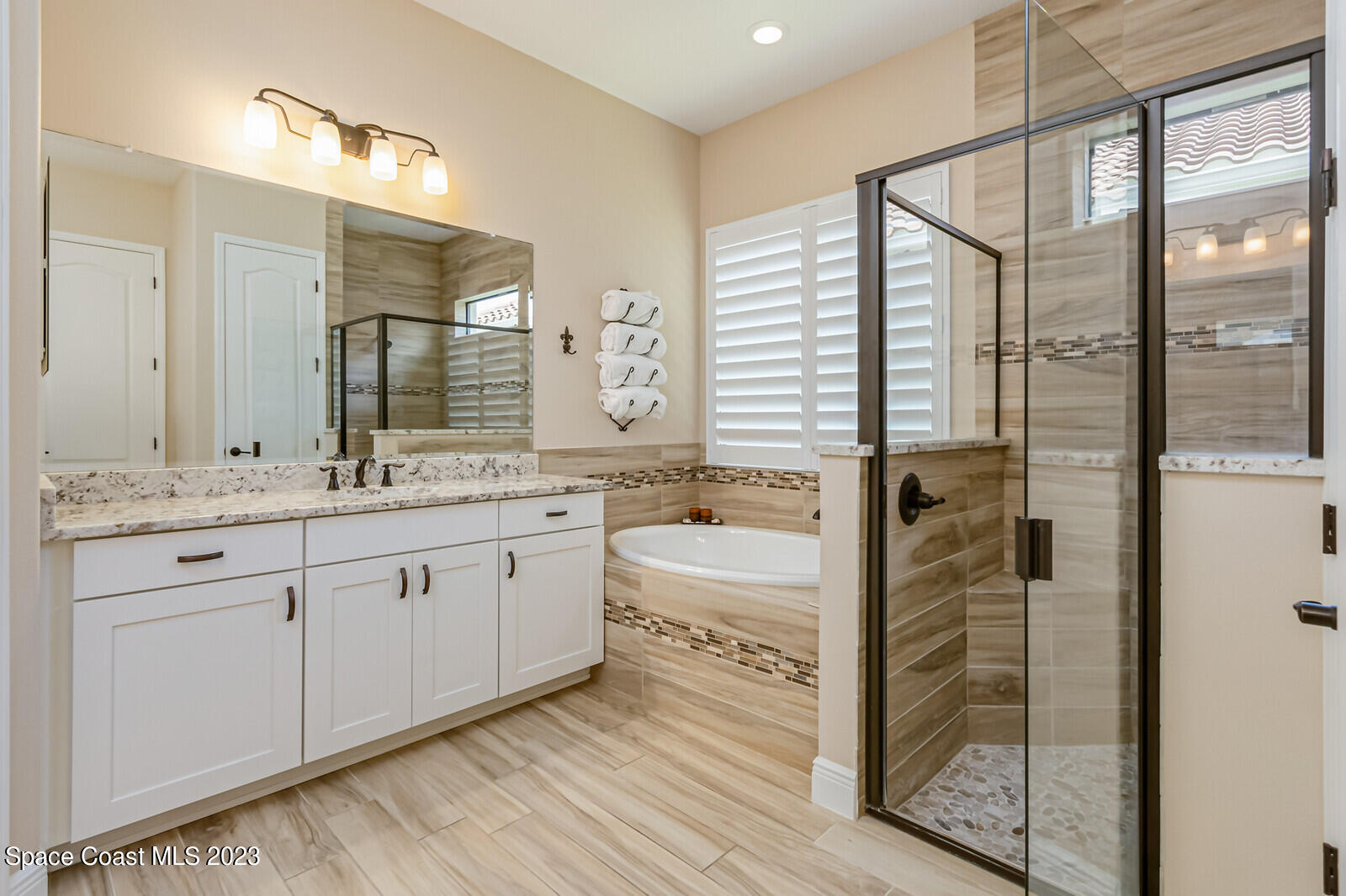 2928 Addison Drive Melbourne, FL 32940 - Photo 27 of 69 a spacious bathroom with a granite countertop sink and a mirror