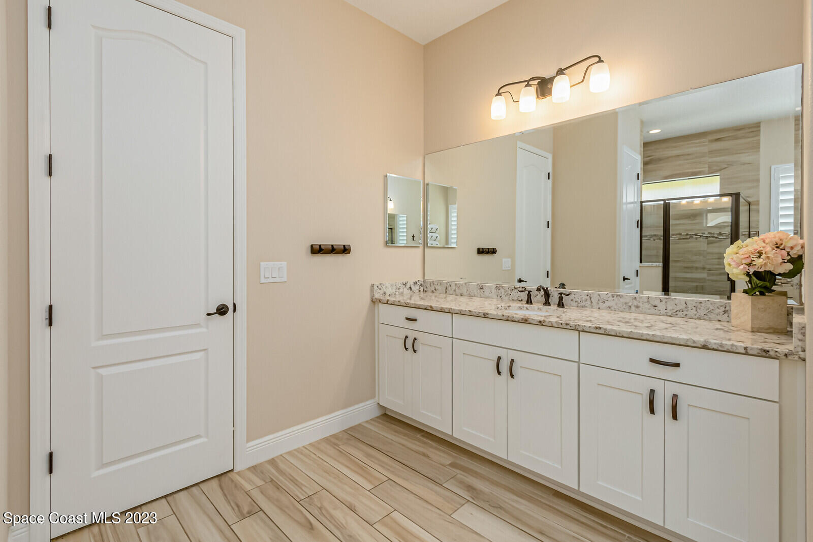 2928 Addison Drive Melbourne, FL 32940 - Photo 29 of 69 a bathroom with a granite countertop sink and a mirror