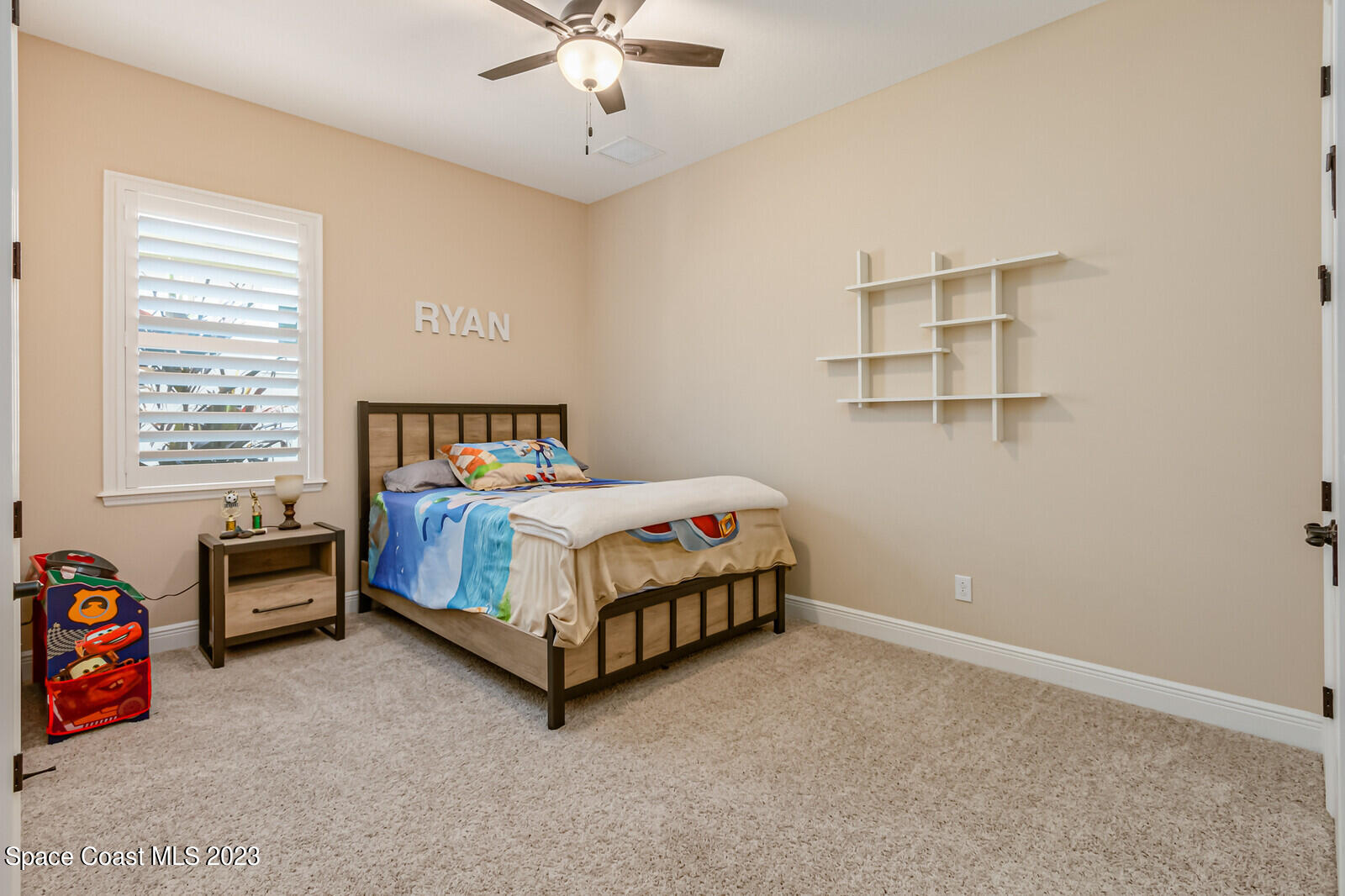 2928 Addison Drive Melbourne, FL 32940 - Photo 30 of 69 a bedroom with a bed and a chandelier