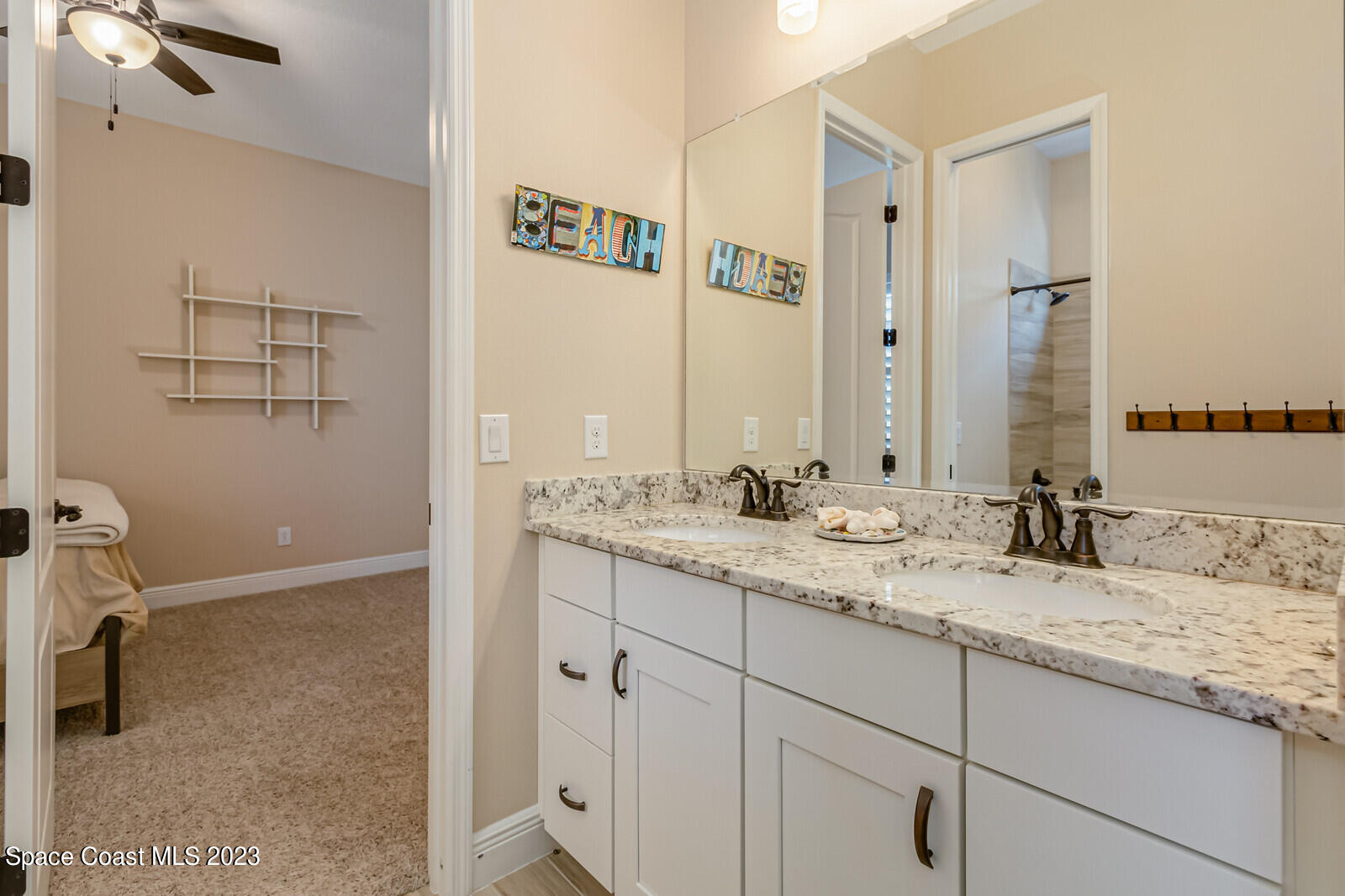 2928 Addison Drive Melbourne, FL 32940 - Photo 31 of 69 a bathroom with a granite countertop sink and a mirror