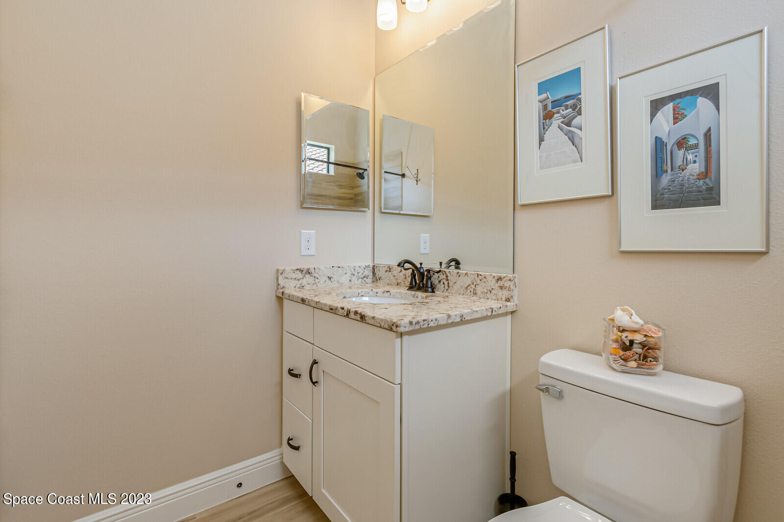 2928 Addison Drive Melbourne, FL 32940 - Photo 37 of 69 a bathroom with a granite countertop sink and a toilet