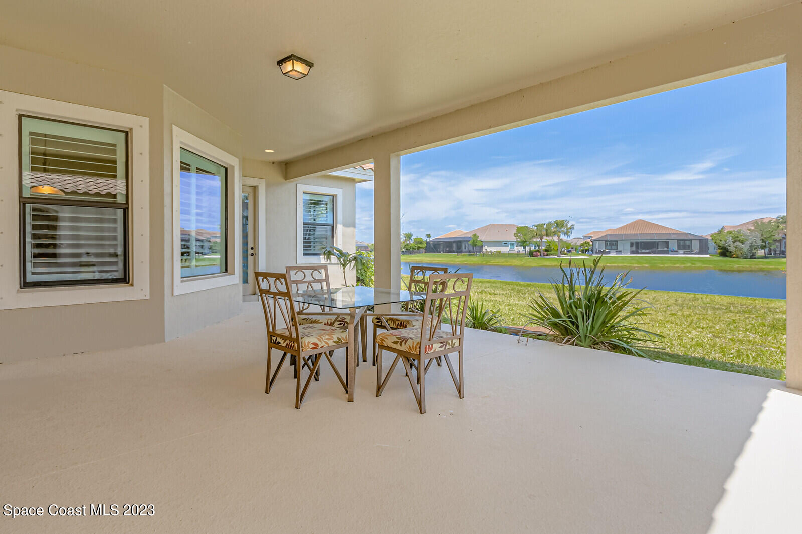 2928 Addison Drive Melbourne, FL 32940 - Photo 39 of 69 a dining room with furniture and a floor to ceiling window