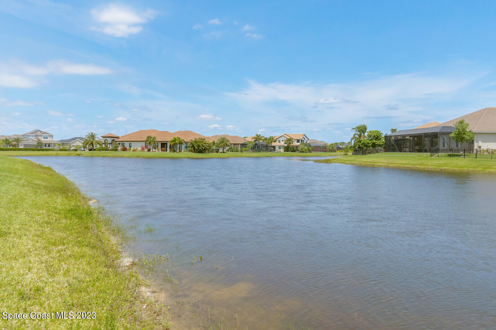 2928 Addison Drive Melbourne, FL 32940 - Photo 44 of 69 a view of a lake with houses in the back