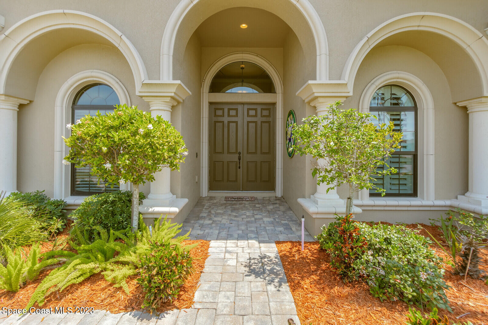 2928 Addison Drive Melbourne, FL 32940 - Photo 5 of 69 a front view of a house with a garden