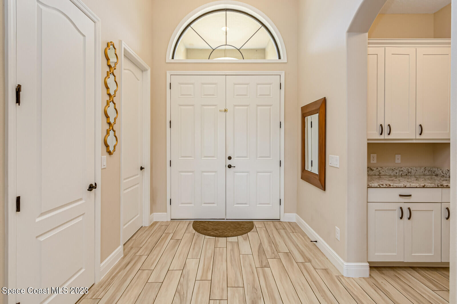2928 Addison Drive Melbourne, FL 32940 - Photo 6 of 69 wooden floor with white cabinets