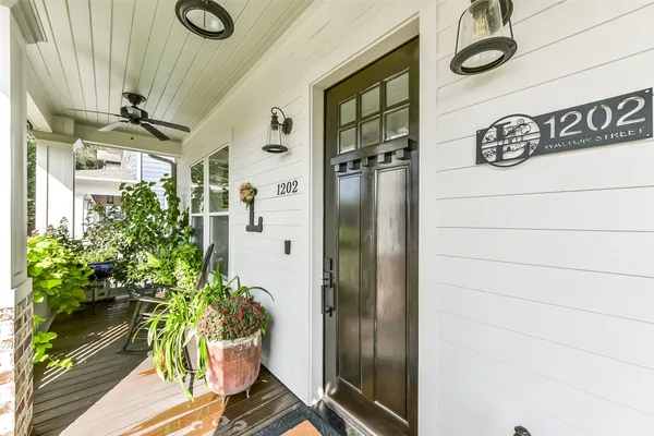 a kitchen with a stove a sink dishwasher a dining table and chairs with wooden floor
