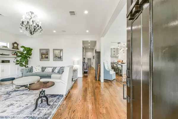 a kitchen with stainless steel appliances granite countertop a stove a sink dishwasher a dining table and chairs with wooden floor