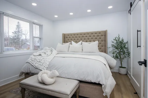 a bedroom with a bed and a fireplace