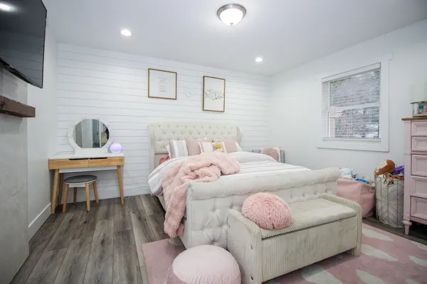 a bedroom with a bed and a flat screen tv