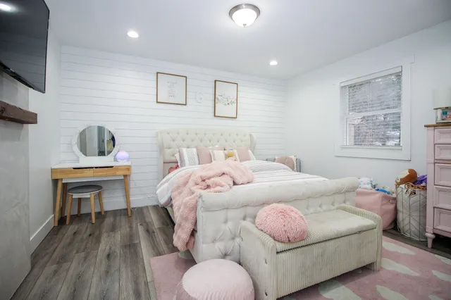 a bedroom with a bed and a flat screen tv