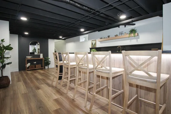 a living room with furniture and a view of kitchen