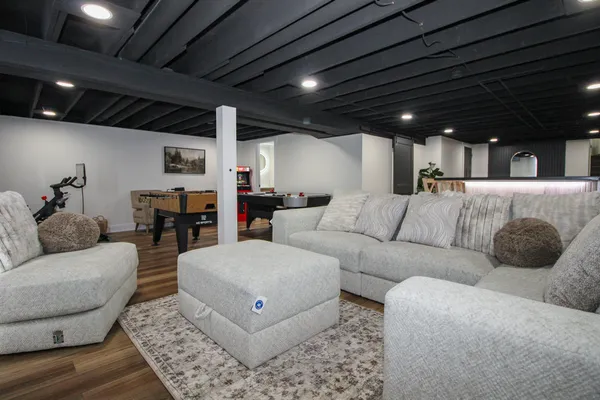 a room with table tennis gym equipment and view of living room
