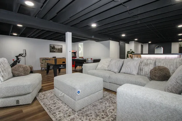 a room with table tennis gym equipment and view of living room