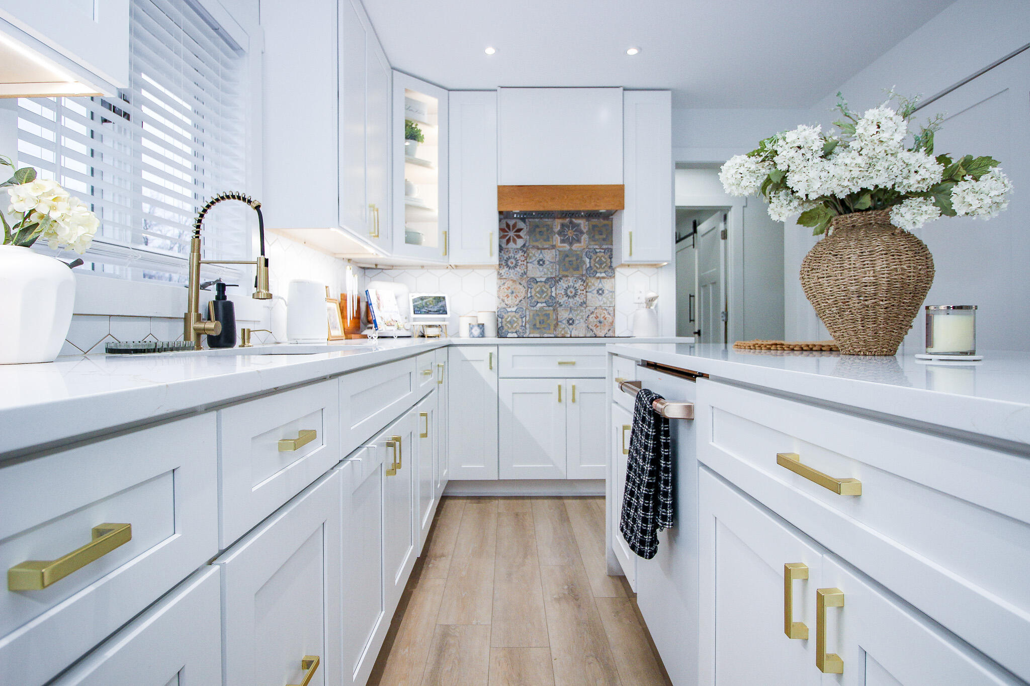 10791 North 1000 West Demotte, IN 46310 - Photo 4 of 55 a kitchen with kitchen island granite countertop a white stove top oven a sink with white cabinets and wooden floor