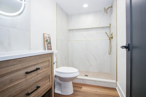 a view of house with yard and trees in the background