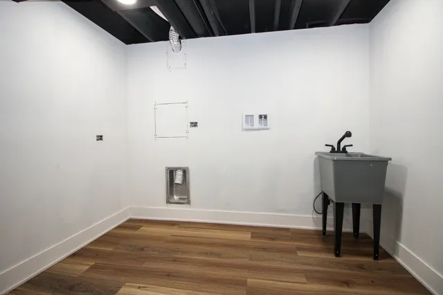 a view of a patio with a table and chairs under an umbrella with large tree