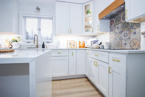 a kitchen with stainless steel appliances a refrigerator sink and cabinets