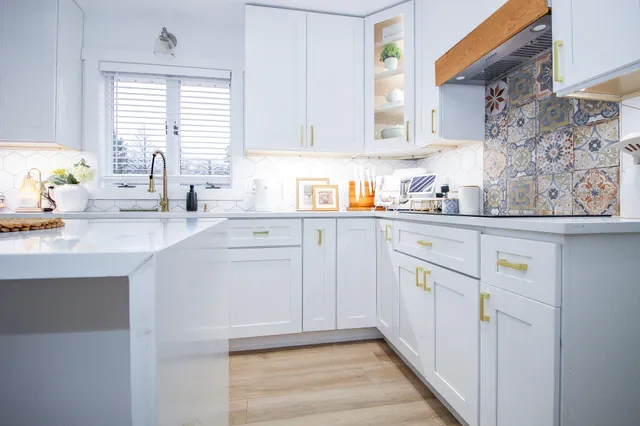 a kitchen with stainless steel appliances a refrigerator sink and cabinets
