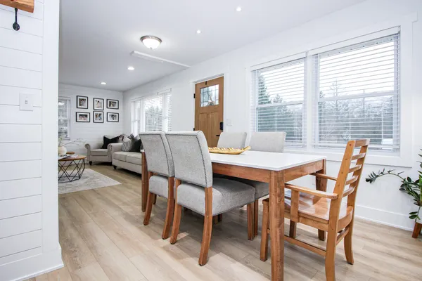 a view of a dining room with furniture window and wooden floor