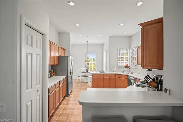 a kitchen with counter top space a sink and stainless steel appliances