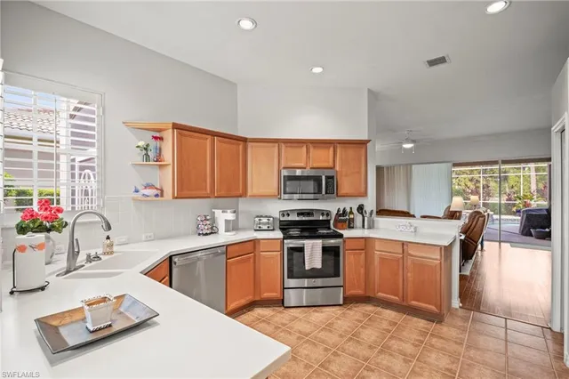 a kitchen with a sink a stove and chairs