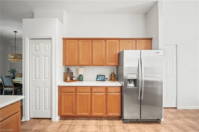 a kitchen with a refrigerator sink and cabinets